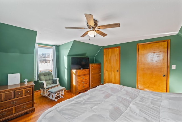 bedroom featuring ceiling fan, lofted ceiling, and light hardwood / wood-style flooring