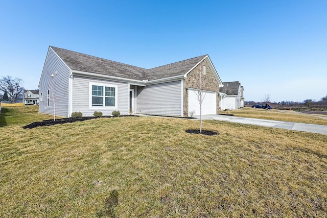 ranch-style house featuring a garage, driveway, and a front lawn