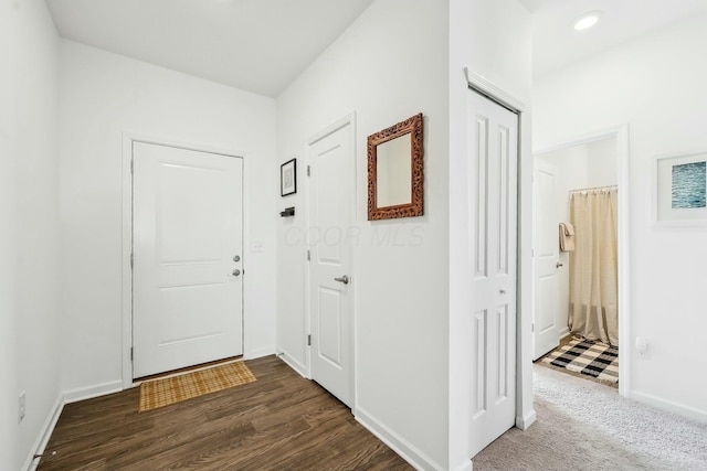 corridor featuring dark wood-style floors, baseboards, and recessed lighting