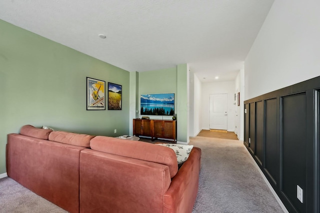 living room featuring carpet floors and baseboards