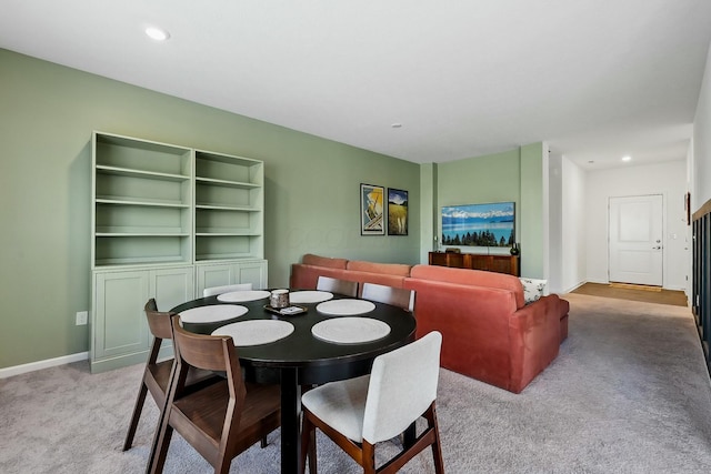 dining room featuring baseboards, recessed lighting, and light colored carpet