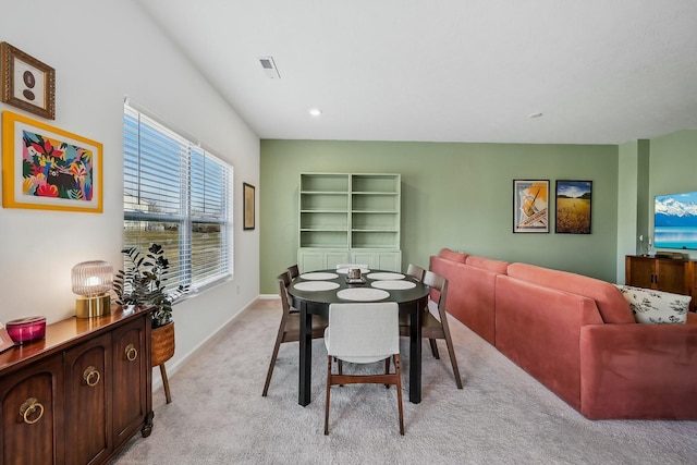 dining area with visible vents, light carpet, and baseboards