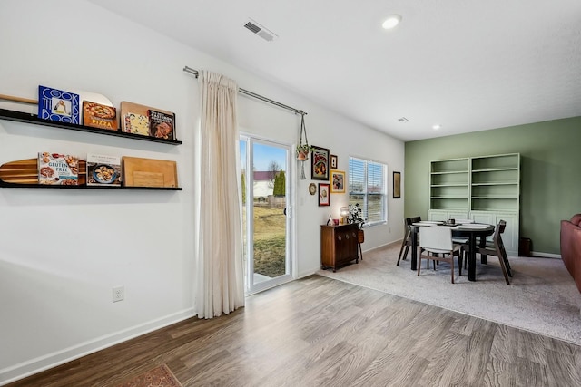 dining space featuring recessed lighting, wood finished floors, and baseboards