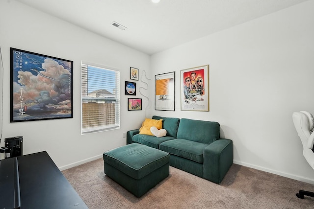 carpeted living area featuring visible vents and baseboards