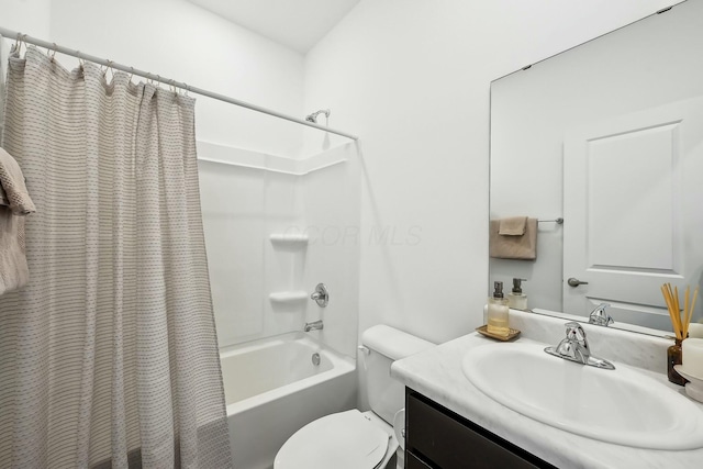 bathroom with shower / bath combo, vanity, and toilet