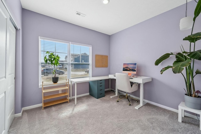 office area with carpet flooring, visible vents, and baseboards