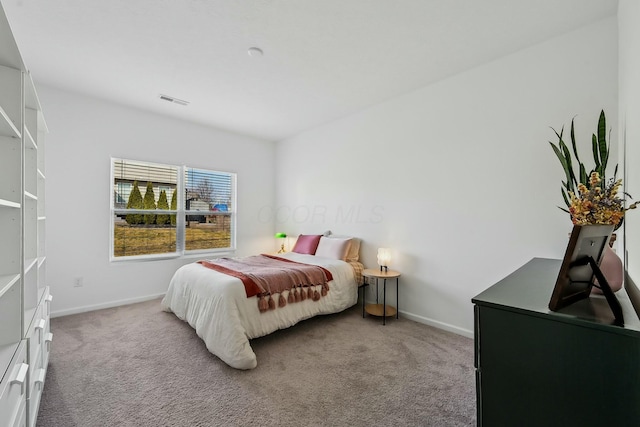 bedroom with carpet floors, baseboards, and visible vents