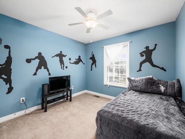 bedroom featuring ceiling fan, light colored carpet, and a textured ceiling