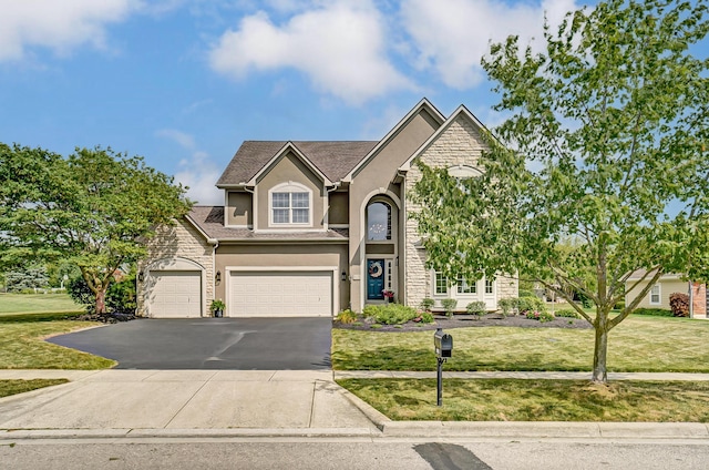 view of front of home featuring a garage and a front lawn