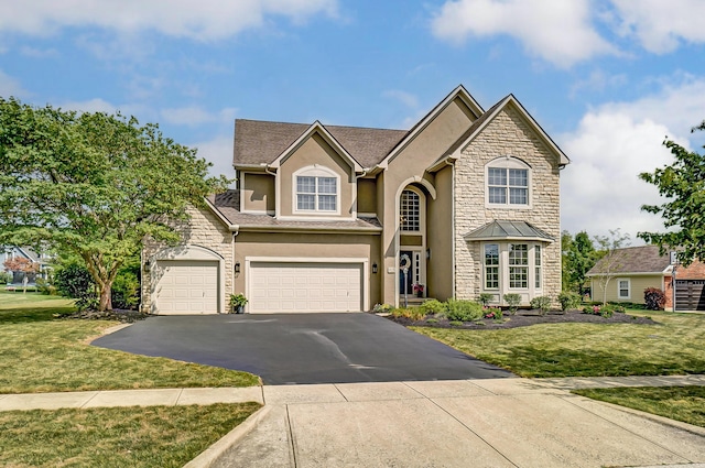 view of front facade with a garage and a front lawn