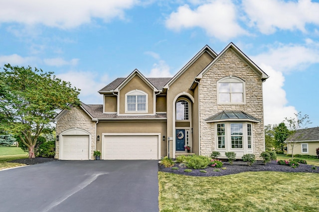 view of front of home with a garage and a front yard