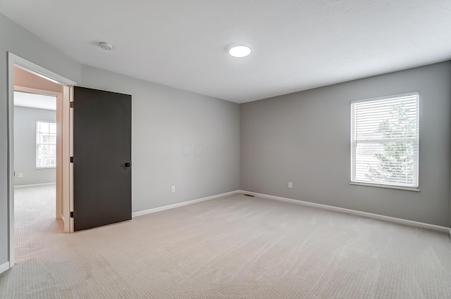 unfurnished room with light carpet