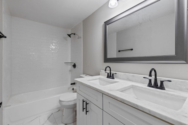 full bathroom with tiled shower / bath, vanity, and toilet