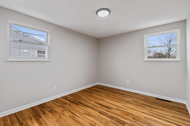 spare room featuring light hardwood / wood-style flooring