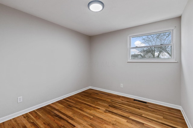 empty room with hardwood / wood-style flooring