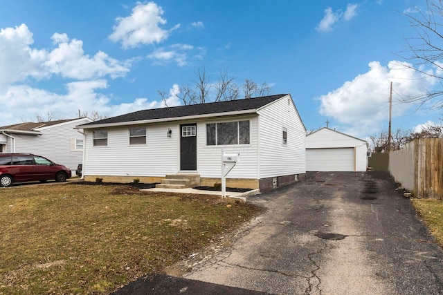 view of front of property with a garage, an outdoor structure, and a front yard