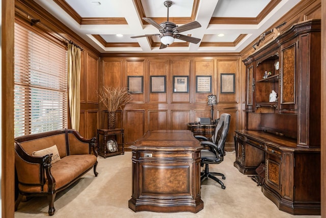 office space with light carpet, coffered ceiling, ceiling fan, ornamental molding, and beamed ceiling