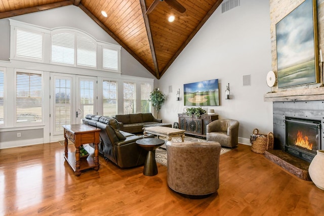 living room with visible vents, wood ceiling, a large fireplace, and wood finished floors