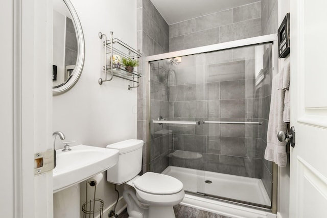 bathroom with toilet and a stall shower