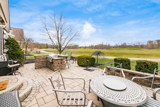 view of patio with area for grilling and outdoor dining space