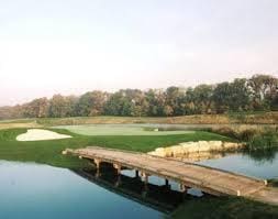 dock area featuring a water view, a lawn, and view of golf course