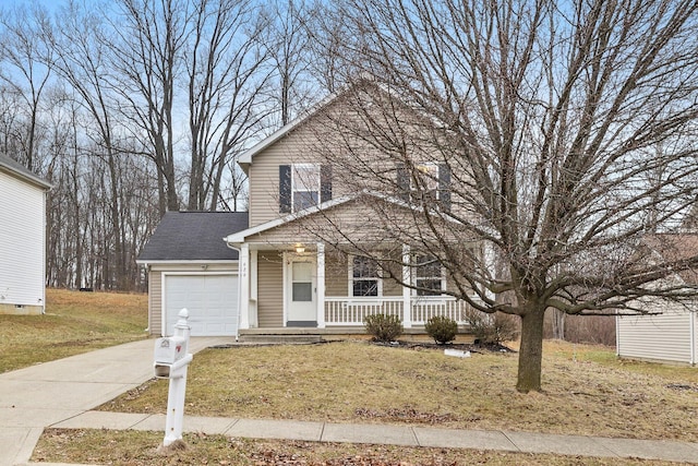 view of front property with a garage, covered porch, and a front yard