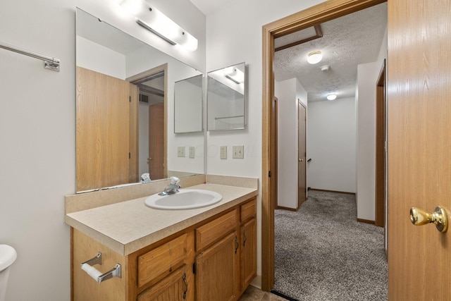 bathroom with vanity and a textured ceiling