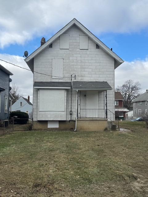 back of house with a lawn