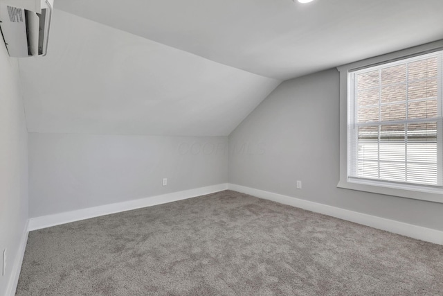 bonus room with carpet and vaulted ceiling