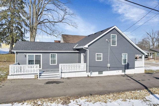 snow covered property featuring covered porch