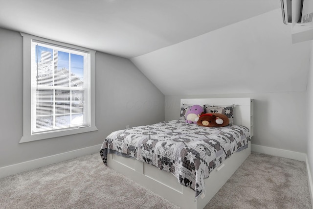 bedroom featuring lofted ceiling and light colored carpet