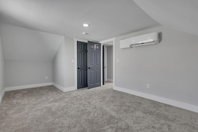 bonus room with a wall mounted air conditioner, carpet, and lofted ceiling