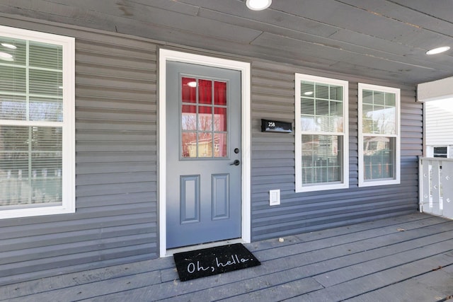 view of exterior entry featuring covered porch