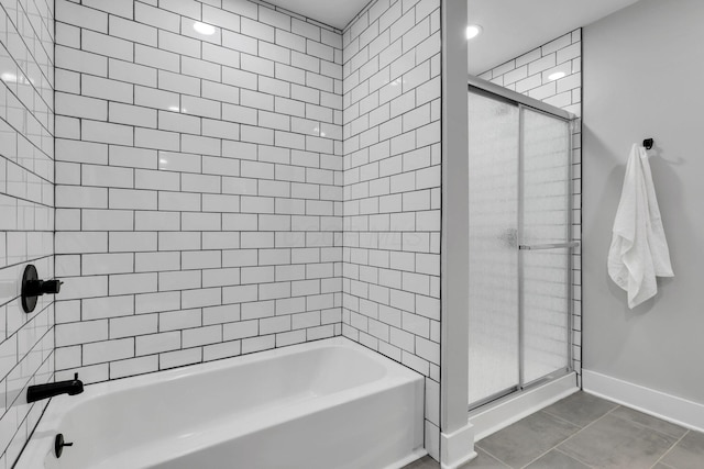 bathroom with tile patterned flooring and tiled shower / bath