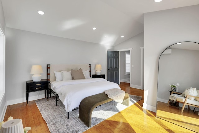 bedroom with vaulted ceiling and hardwood / wood-style floors