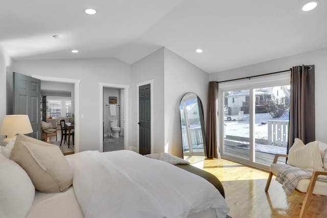 bedroom featuring multiple windows, access to exterior, vaulted ceiling, and light wood-type flooring