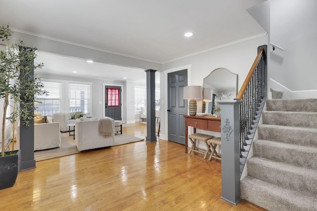 living room with hardwood / wood-style flooring, ornamental molding, and decorative columns