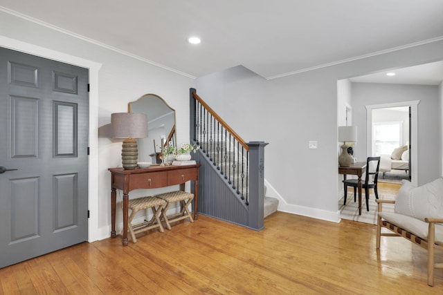 entryway featuring light hardwood / wood-style flooring and crown molding