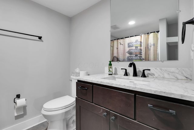 bathroom featuring vanity and toilet