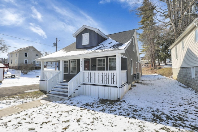 bungalow with covered porch and cooling unit