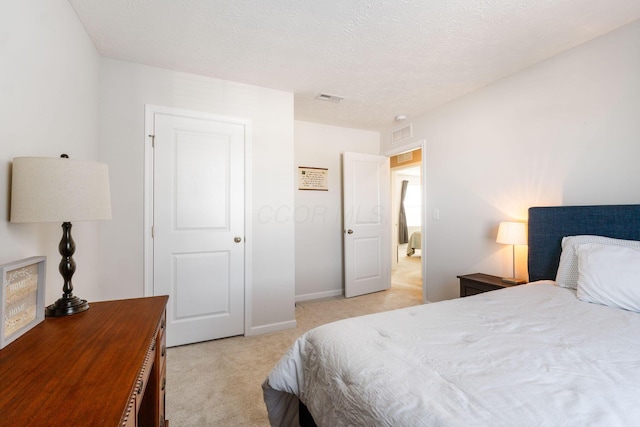 carpeted bedroom with a textured ceiling