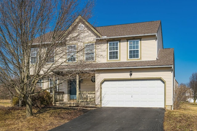 view of front of home featuring a garage, aphalt driveway, and roof with shingles