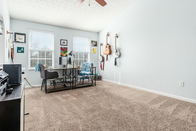 carpeted office with a textured ceiling, a ceiling fan, and baseboards