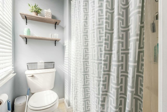 full bath with a wealth of natural light, toilet, and tile patterned floors