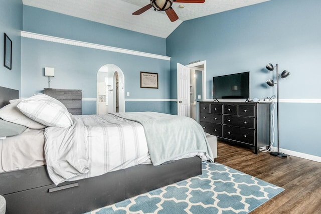 bedroom featuring baseboards, arched walkways, a ceiling fan, lofted ceiling, and dark wood-style floors