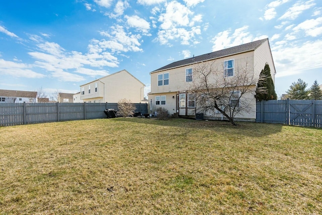 back of property featuring a fenced backyard and a yard