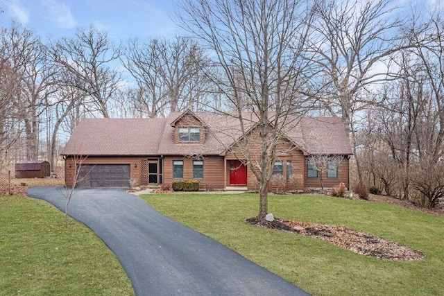 view of front of house with a garage and a front lawn