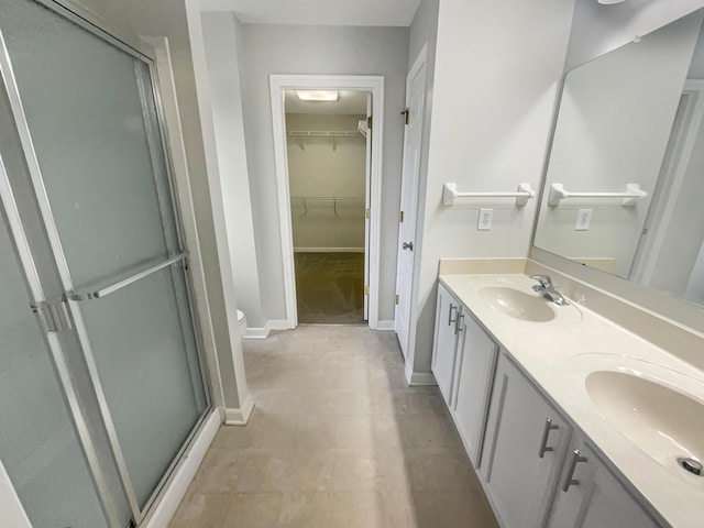 bathroom featuring toilet, vanity, and walk in shower