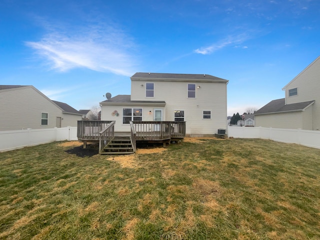 back of property with a deck, central air condition unit, and a lawn