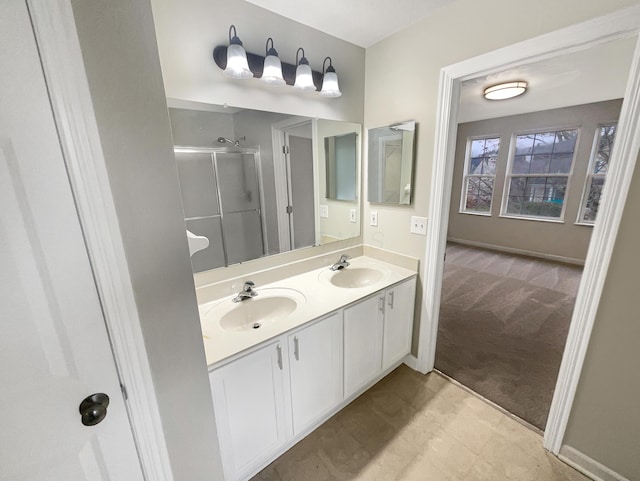 bathroom featuring vanity and a shower with door